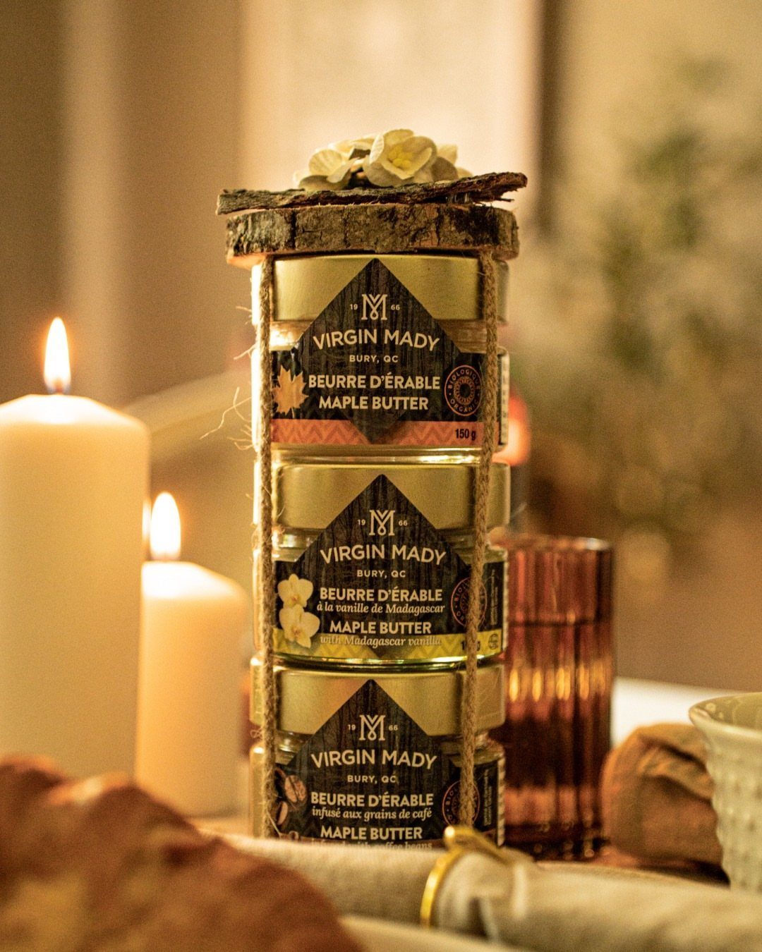 Stacked jars of maple butter tied with twine and topped with a wooden slice.