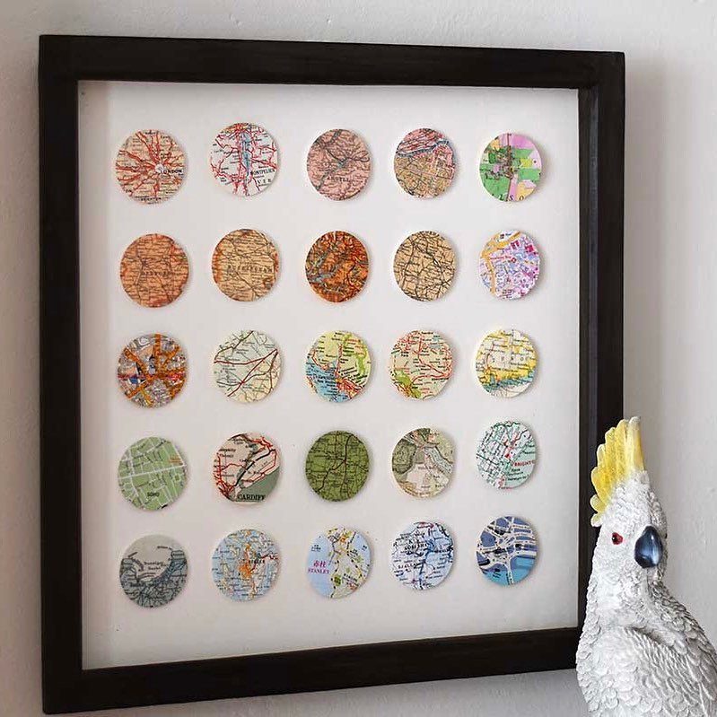 Framed grid of small circular map cutouts on a white background