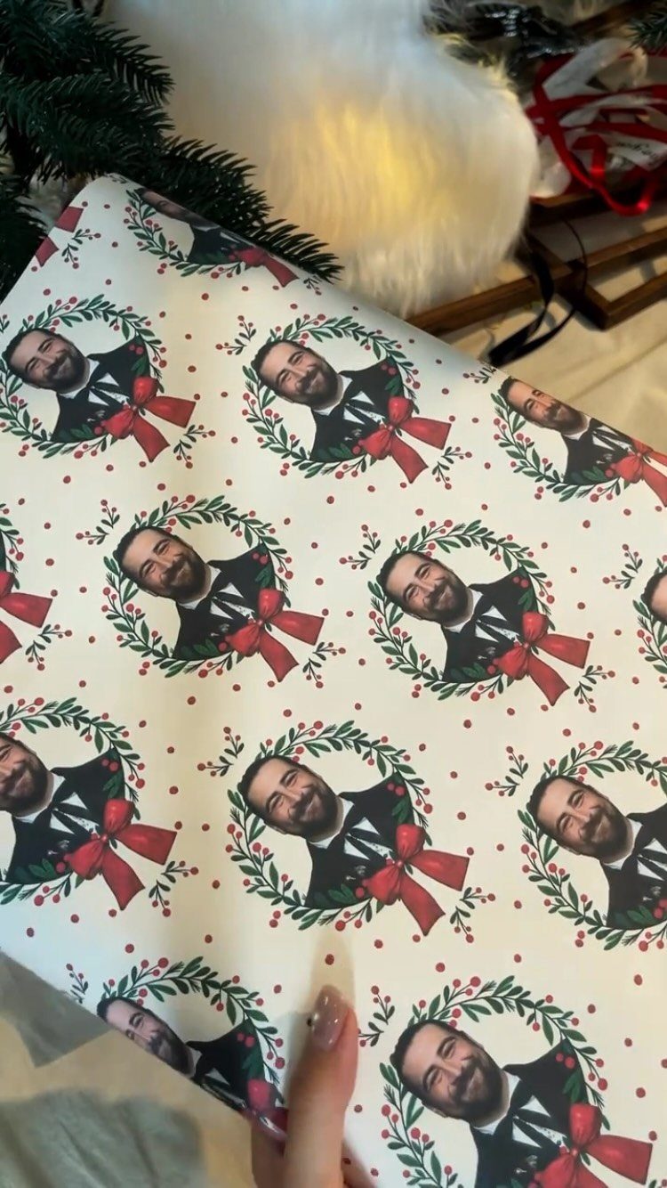Custom wrapping paper with a repeating pattern of a man's face in wreaths.