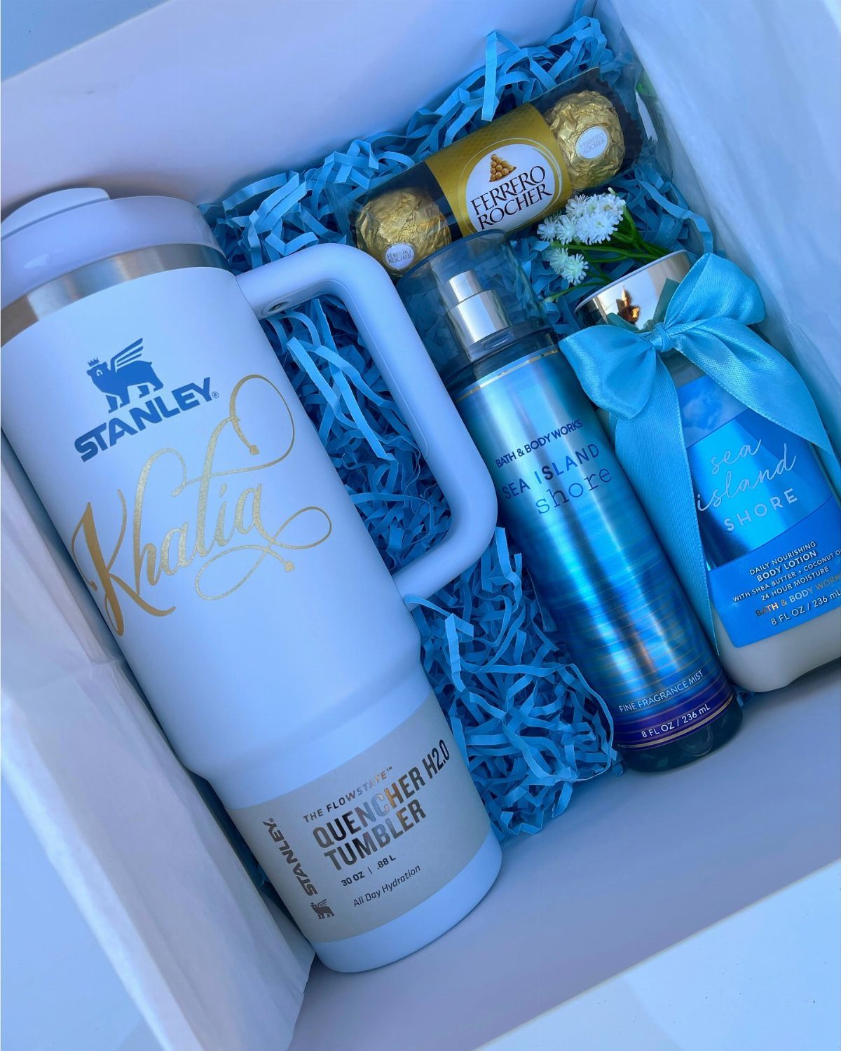 Light blue personalized Stanley tumbler in a gift box with chocolates and toiletries.