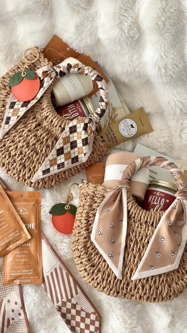 Two woven straw bags with scarves and fruit charms among beauty products.