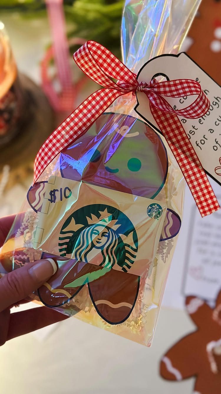 Starbucks gift card inside a gingerbread man cutout in a cellophane bag with ribbon.