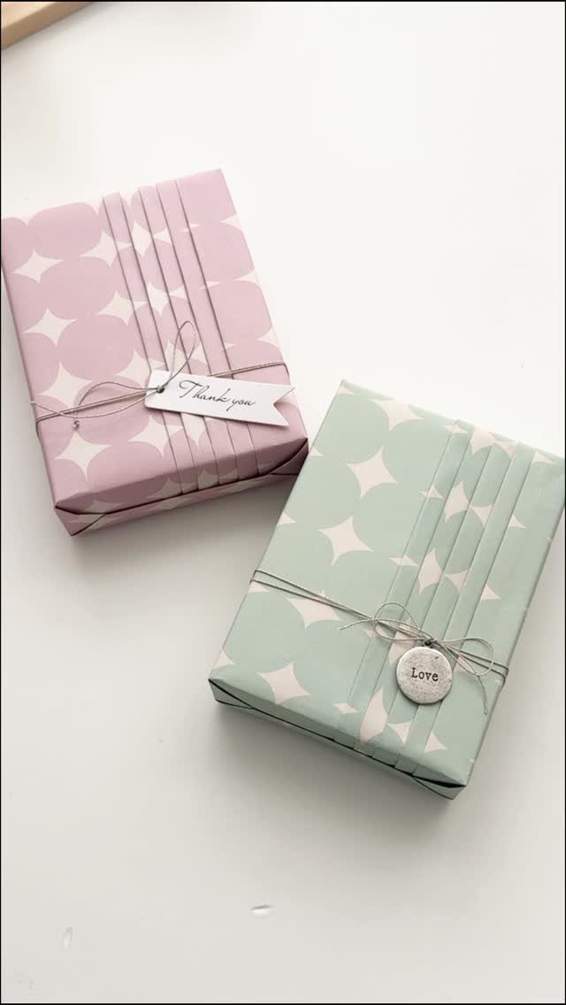 Two small polka dot wrapped gifts with pleated bands and decorative tags.