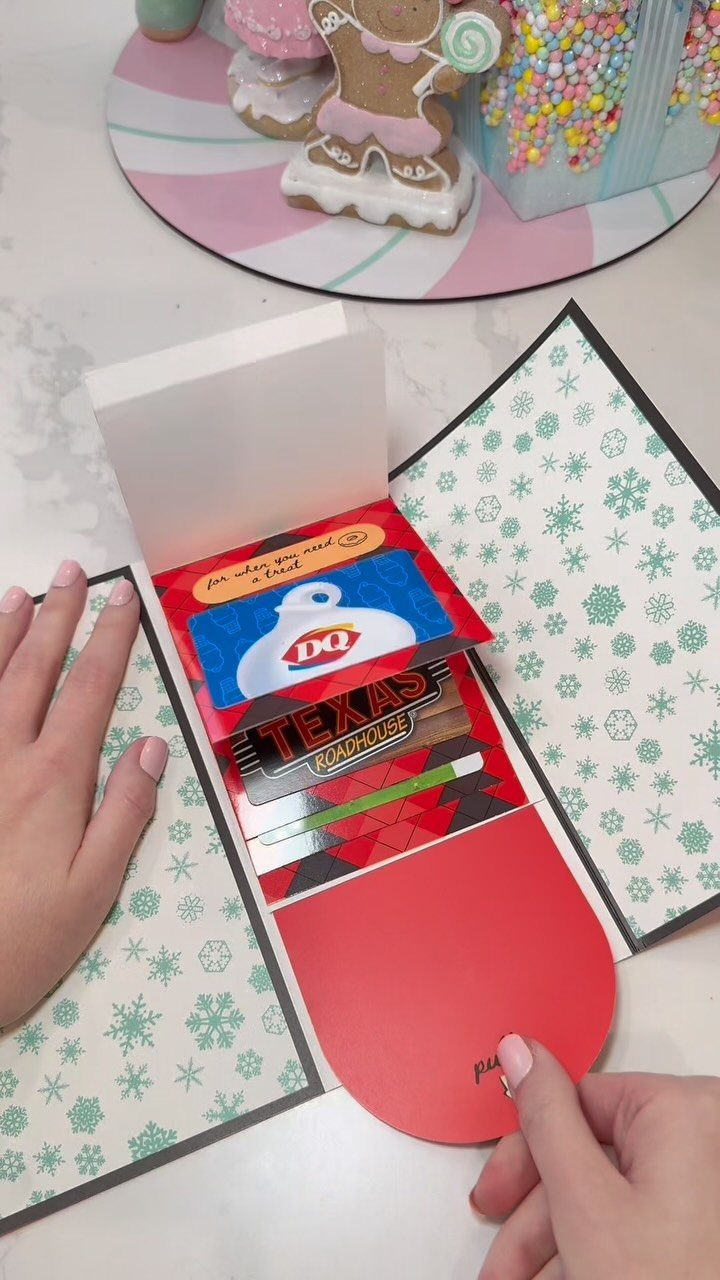 Paper card holder with multiple gift cards and a red lifting flap.