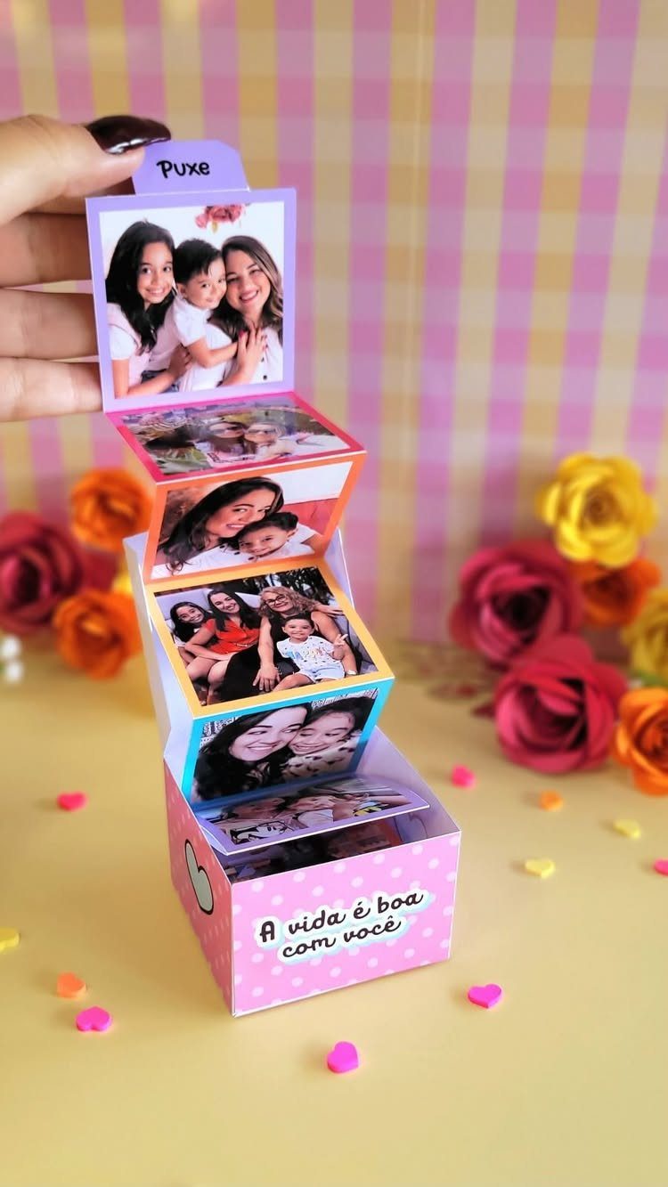 Handmade pink exploding photo box with family pictures and colorful artificial roses.