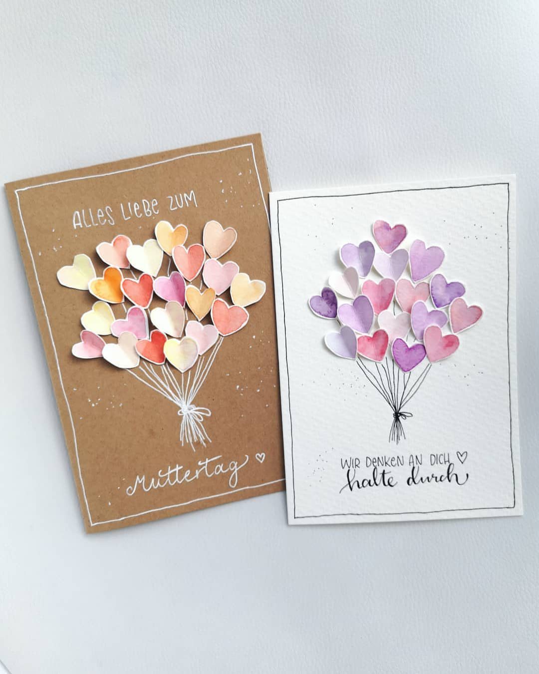 Two handmade greeting cards with 3D pastel paper hearts arranged as bouquets.