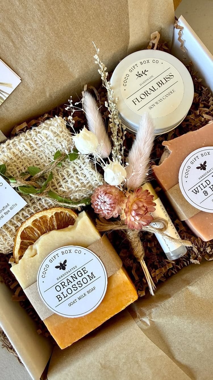 Handmade soap bars and a floral cream jar in a curated gift box.