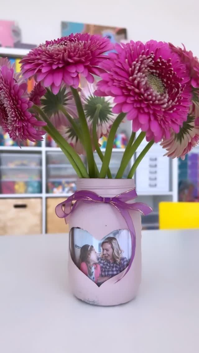 Purple painted mason jar vase with pink daisies and a heart-shaped photo