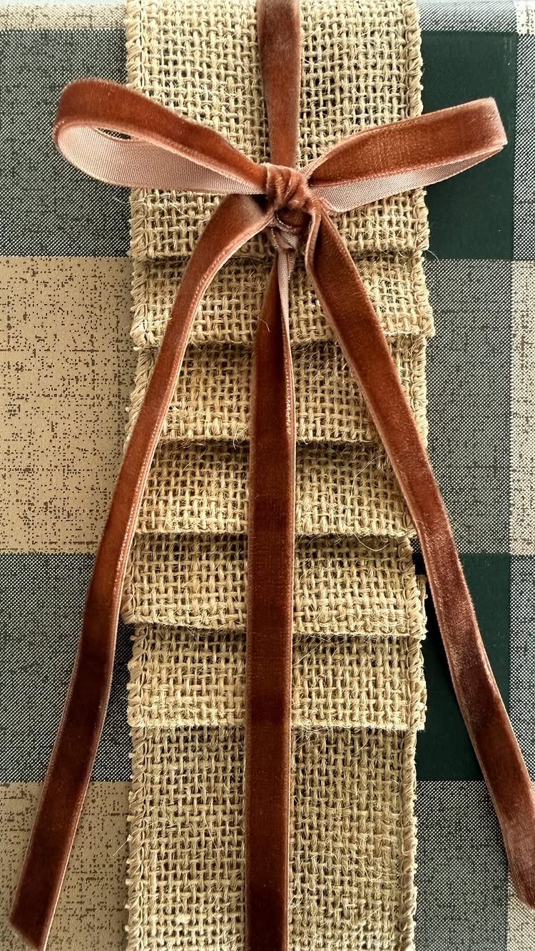 Gift wrapped in plaid fabric and burlap with a brown velvet ribbon bow