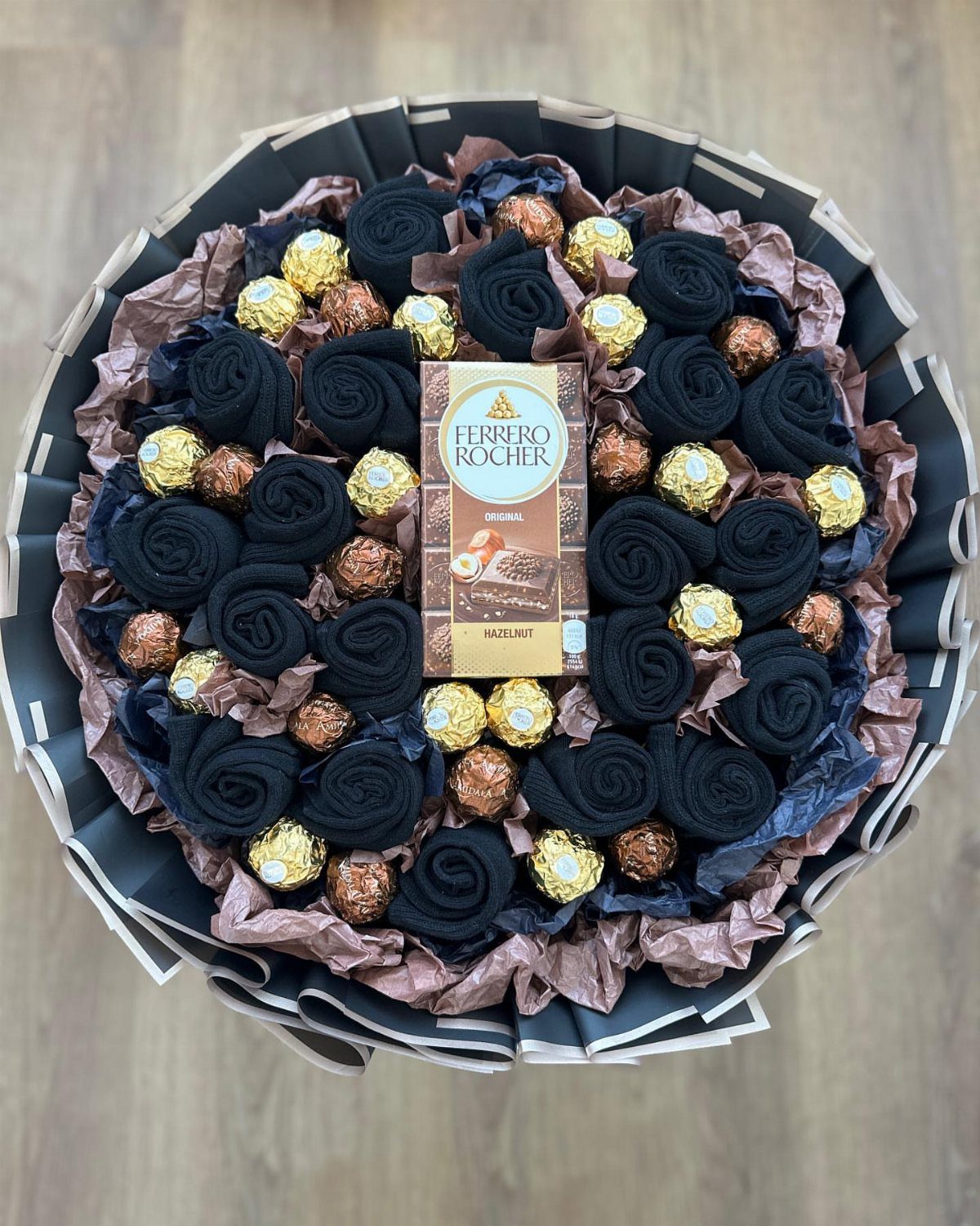 Gift bouquet with black fabric roses and gold-wrapped Ferrero Rocher chocolates.