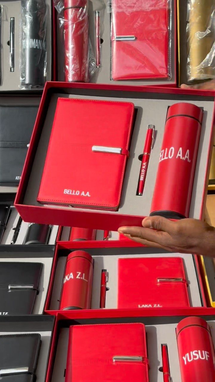 Red personalized gift set with notebook, pen, and bottle in a red box