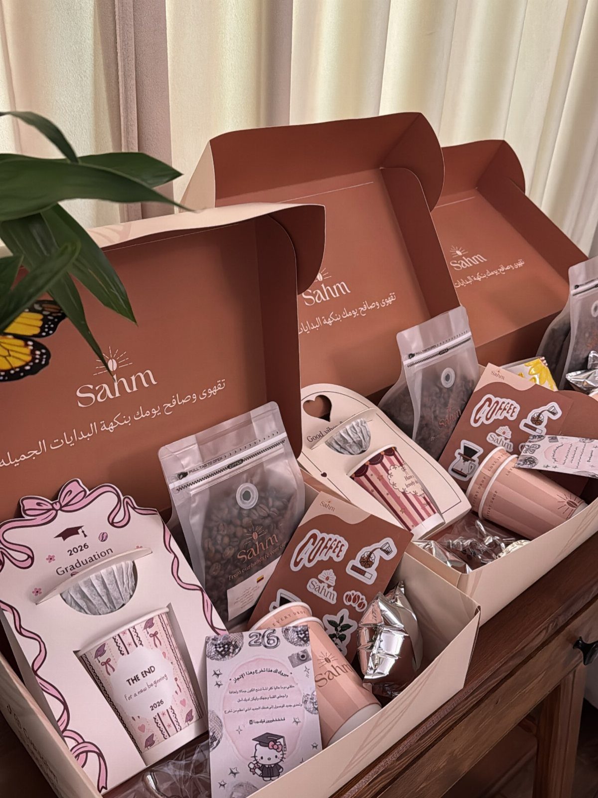 Coffee and tea themed gift boxes with pink cups and coffee bean pouches.