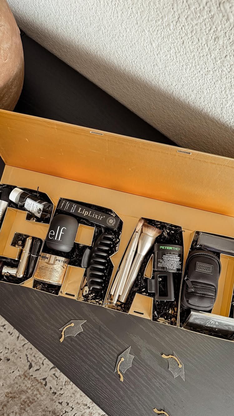 Yellow gift box filled with beauty products and makeup brushes for graduation.