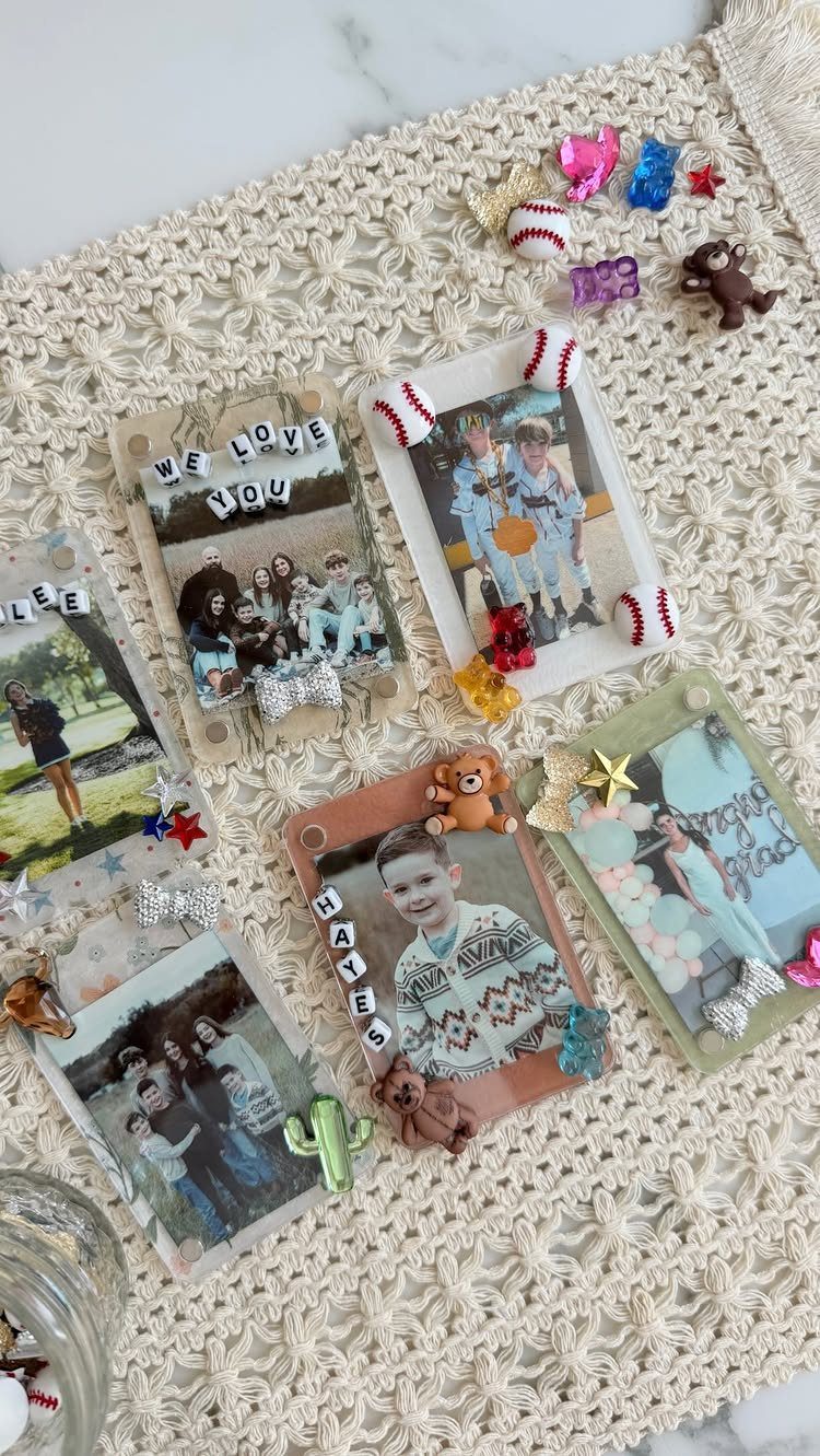 Handmade decorated photo frames with personal pictures on a white lace tablecloth.