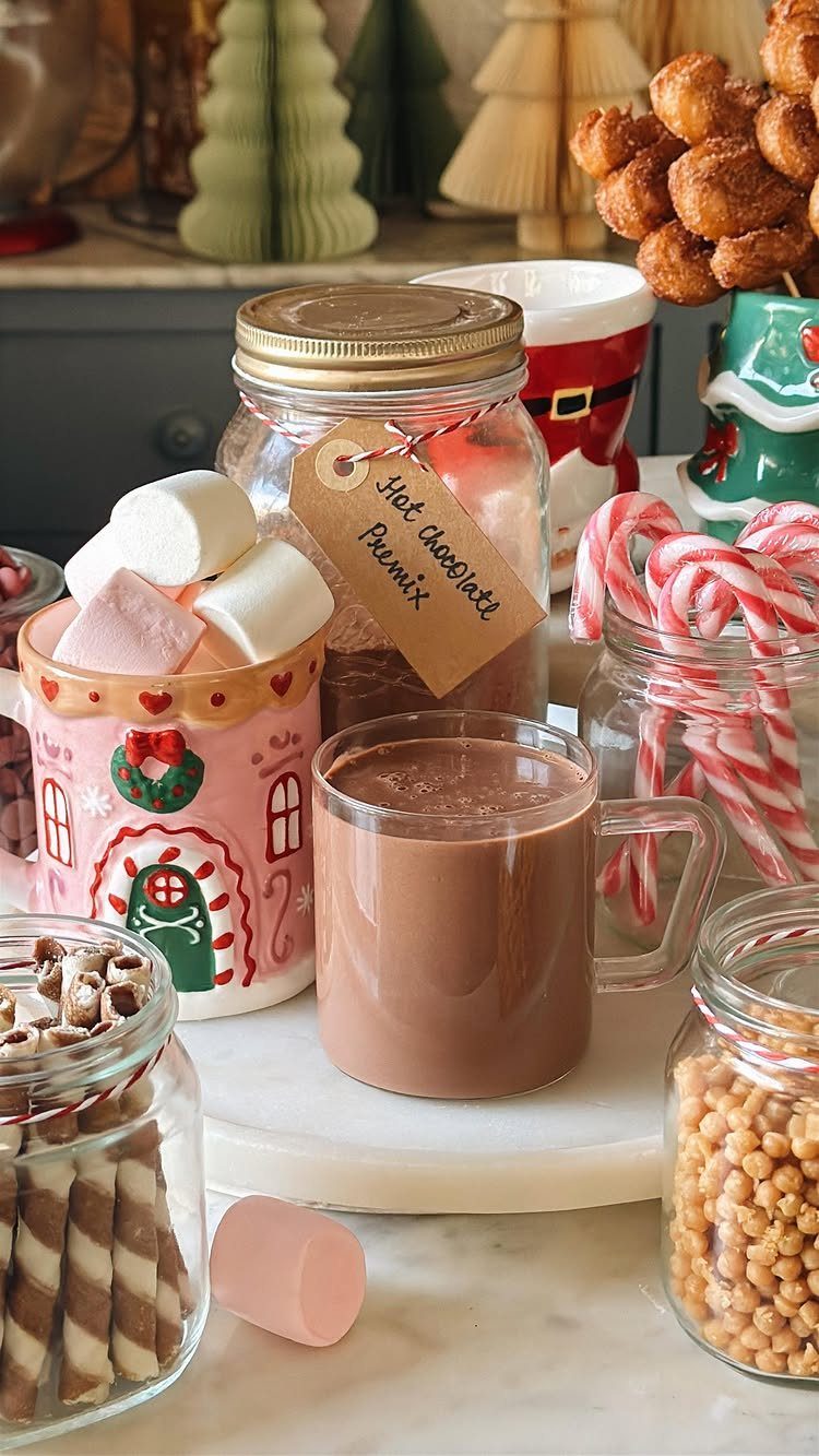Hot chocolate premix in a mason jar next to a mug of cocoa.