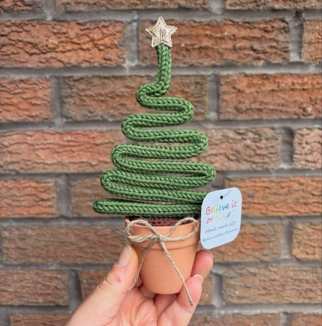 Miniature Christmas tree made of green rope in a small terracotta pot.