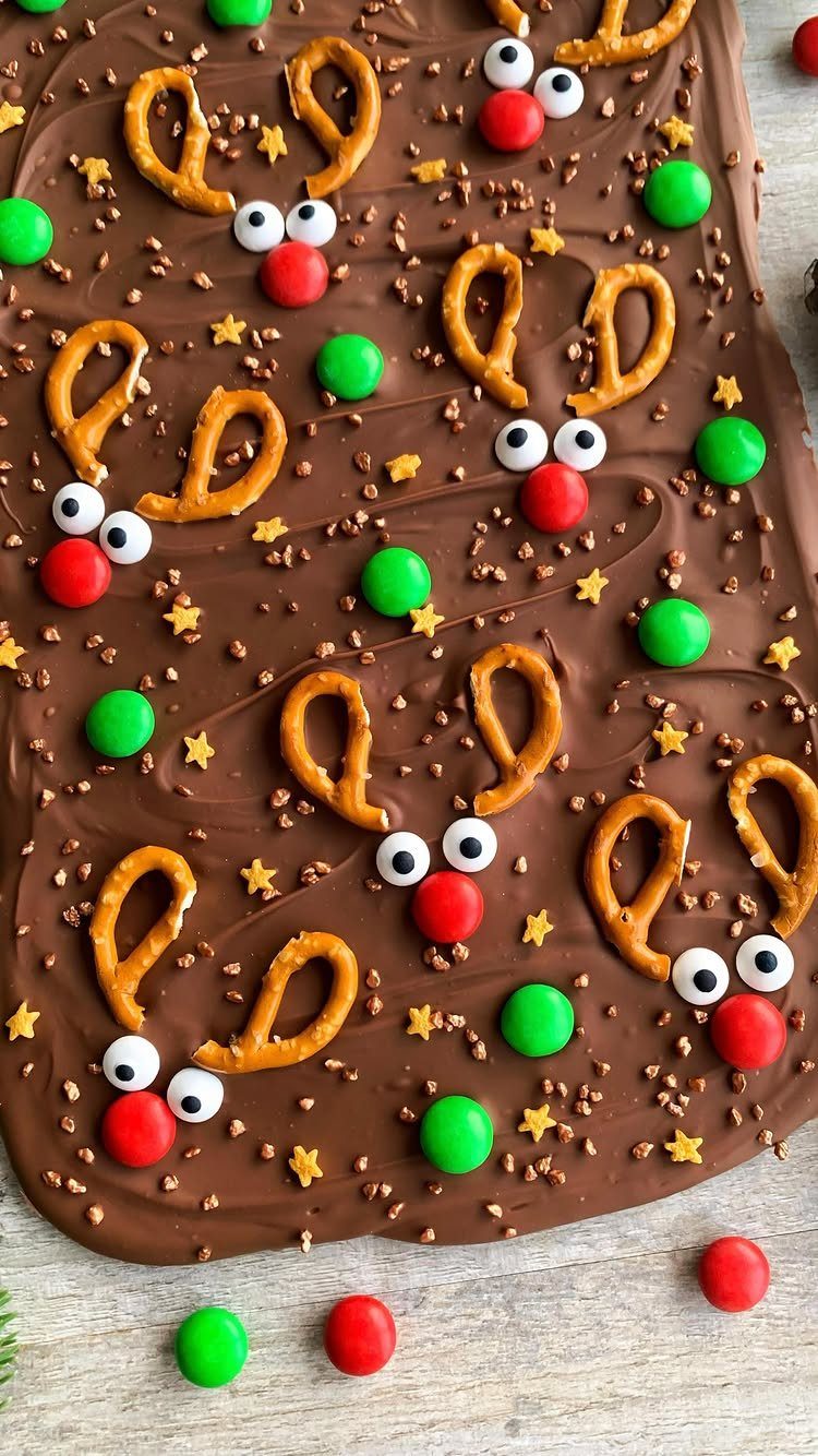 Chocolate bark decorated with pretzel antlers and candy faces to look like reindeer.
