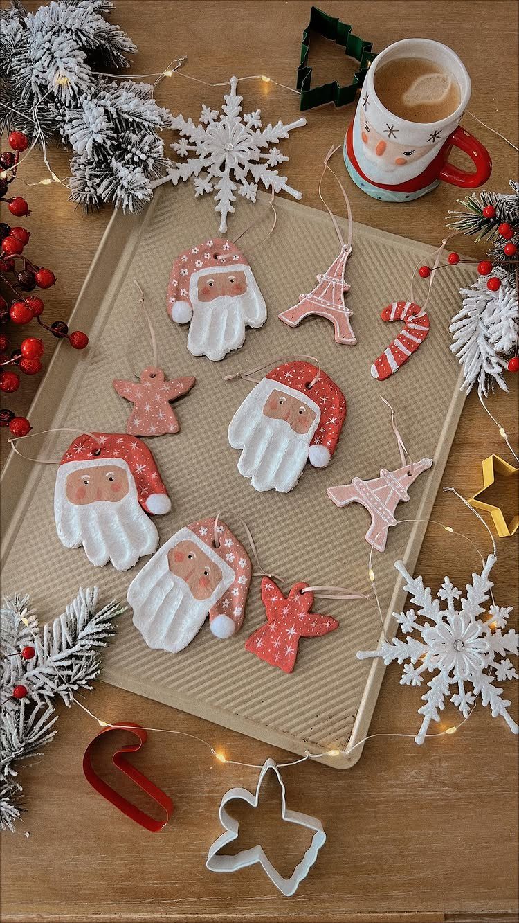 Salt dough ornaments in various shapes arranged on a baking sheet with holiday decorations.