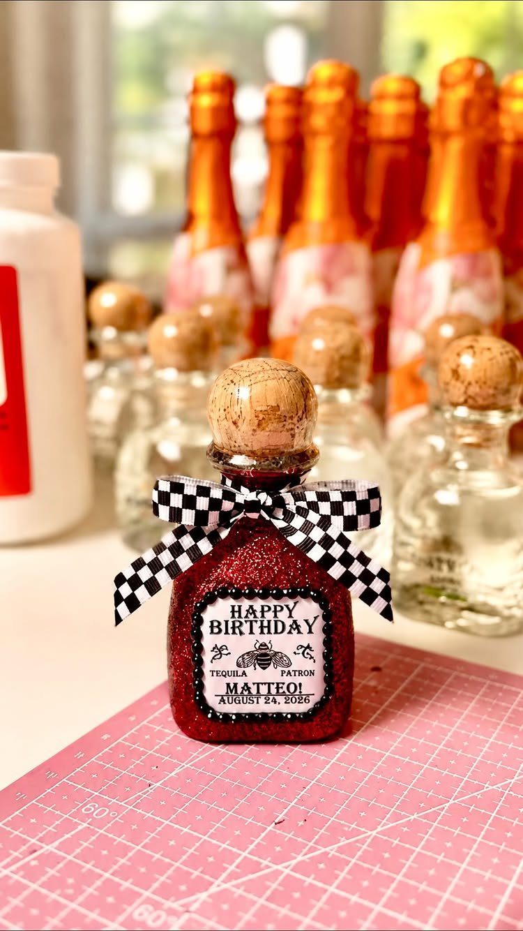 Small red glittery cocktail bottle with a birthday label and checkered bow.
