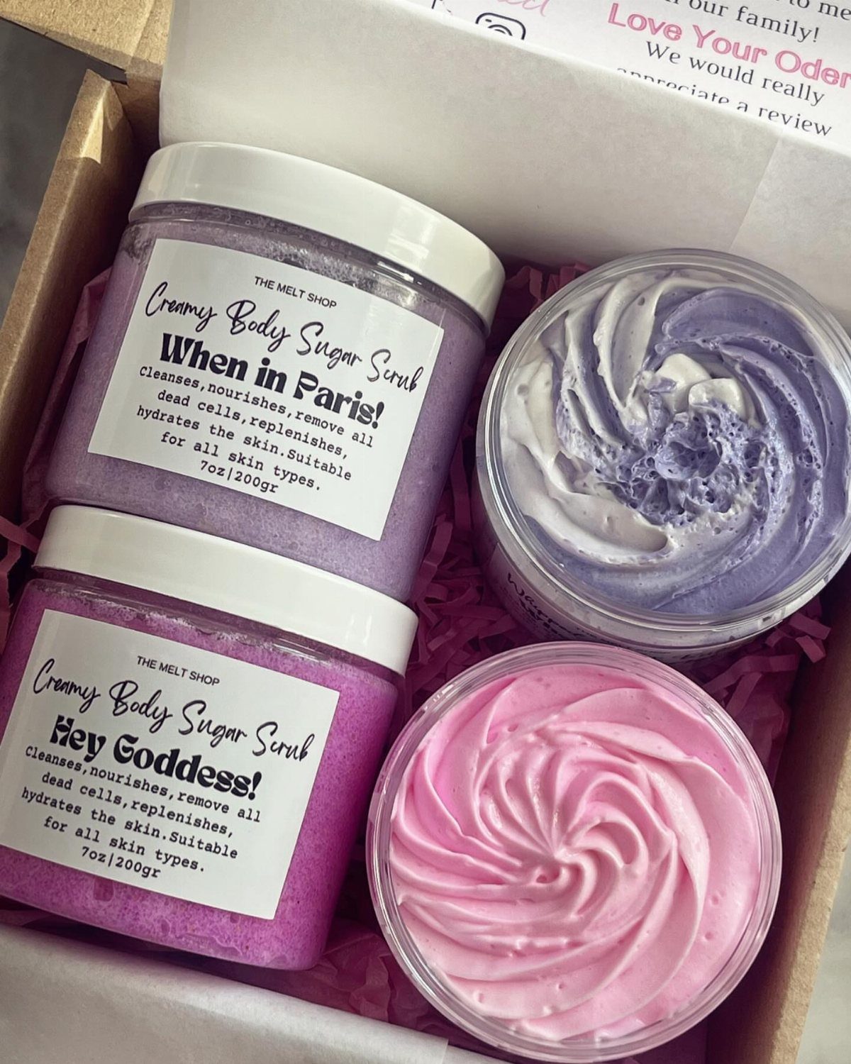Three colorful jars of body sugar scrub in a gift box with shredding