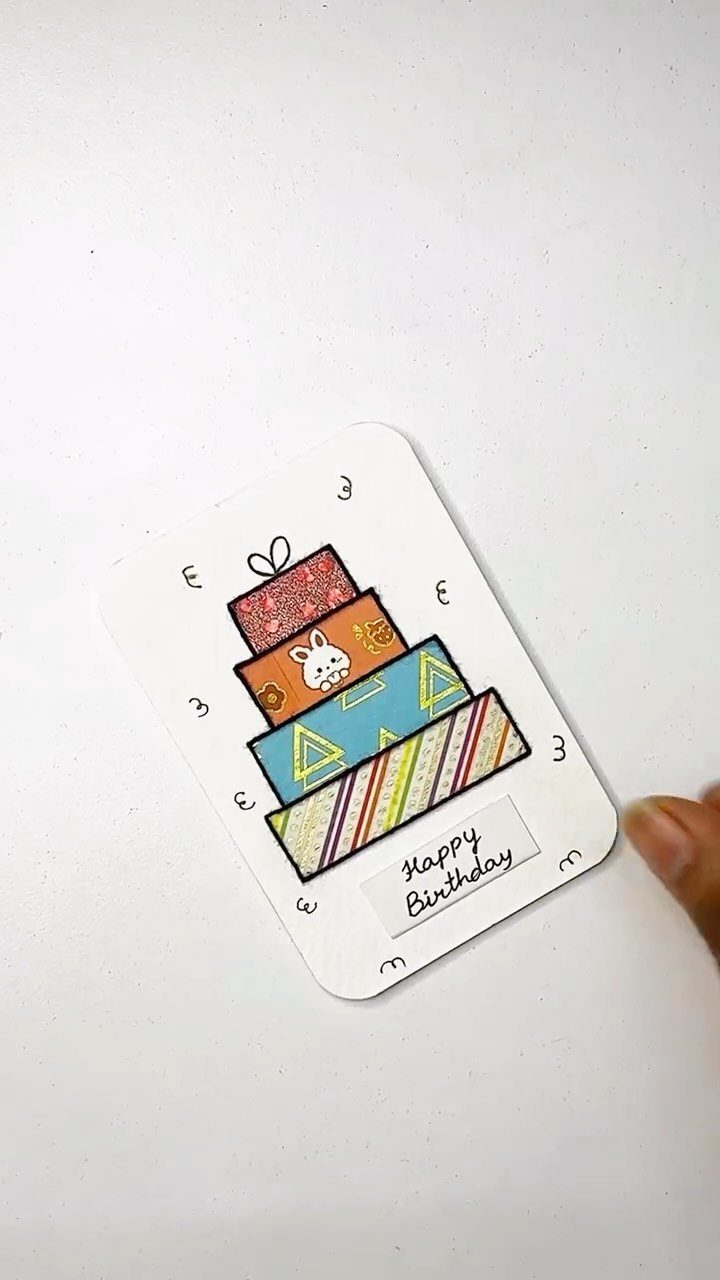 Handmade birthday card featuring a stack of colorful patterned presents and birthday text.