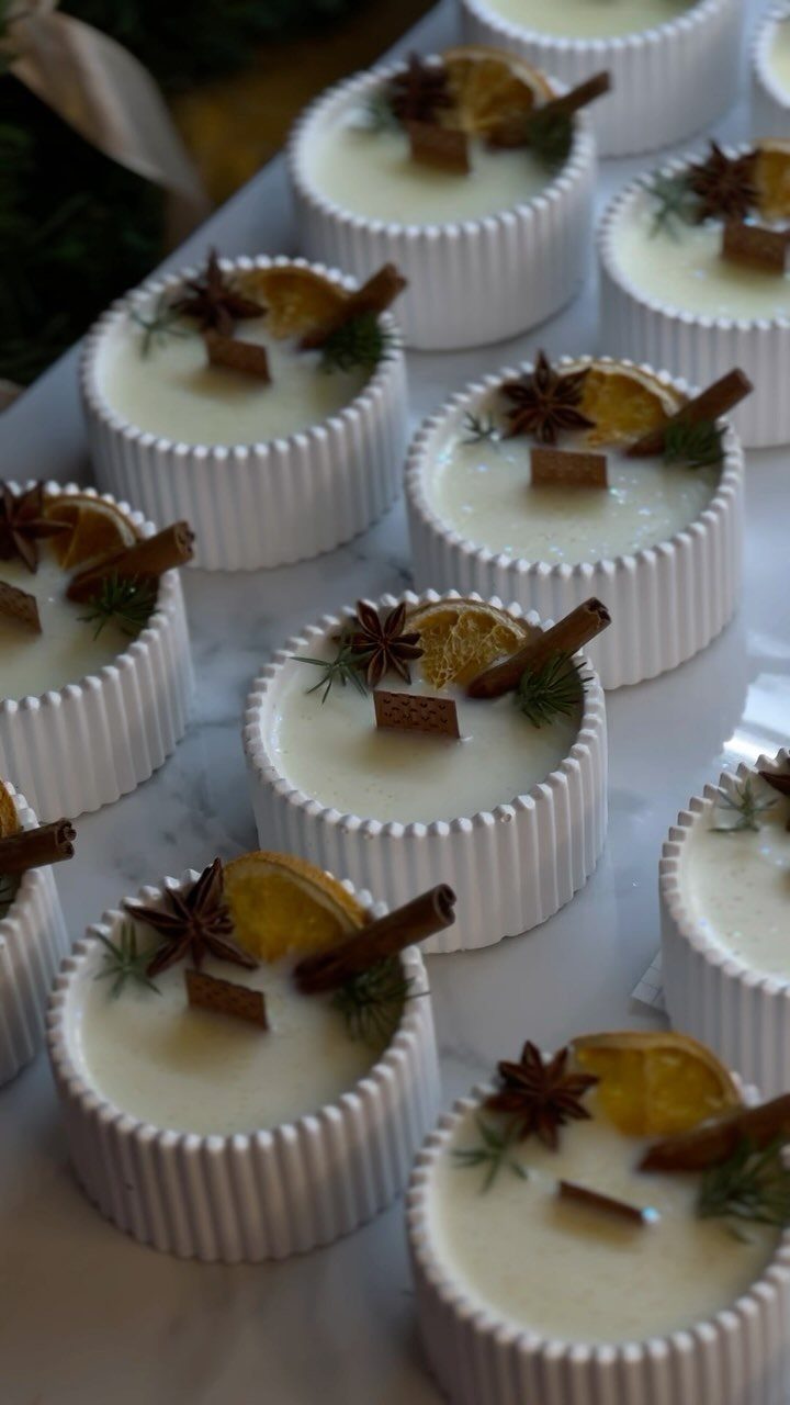 White ribbed candles decorated with dried orange slices, cinnamon sticks, and star anise.