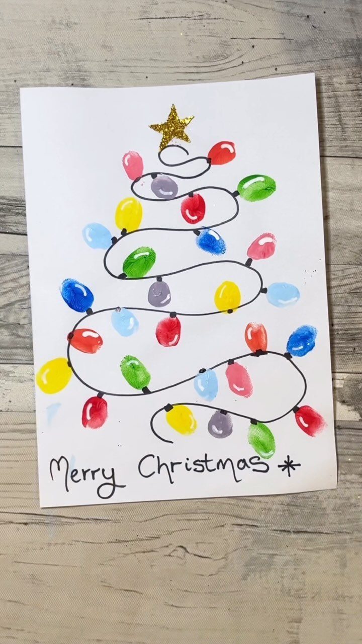 Handmade Christmas card with a fingerprint light tree and gold glitter star.