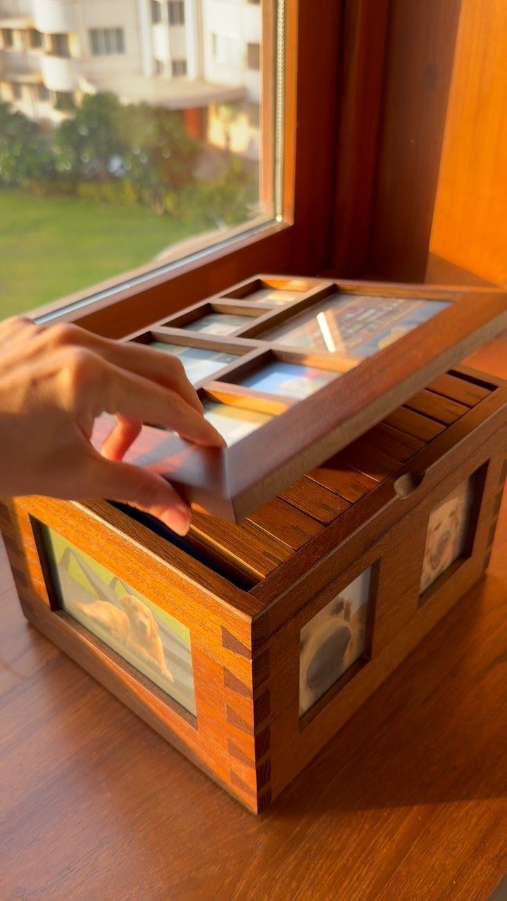 Wooden keepsake photo box with pictures embedded in the sides and lid.