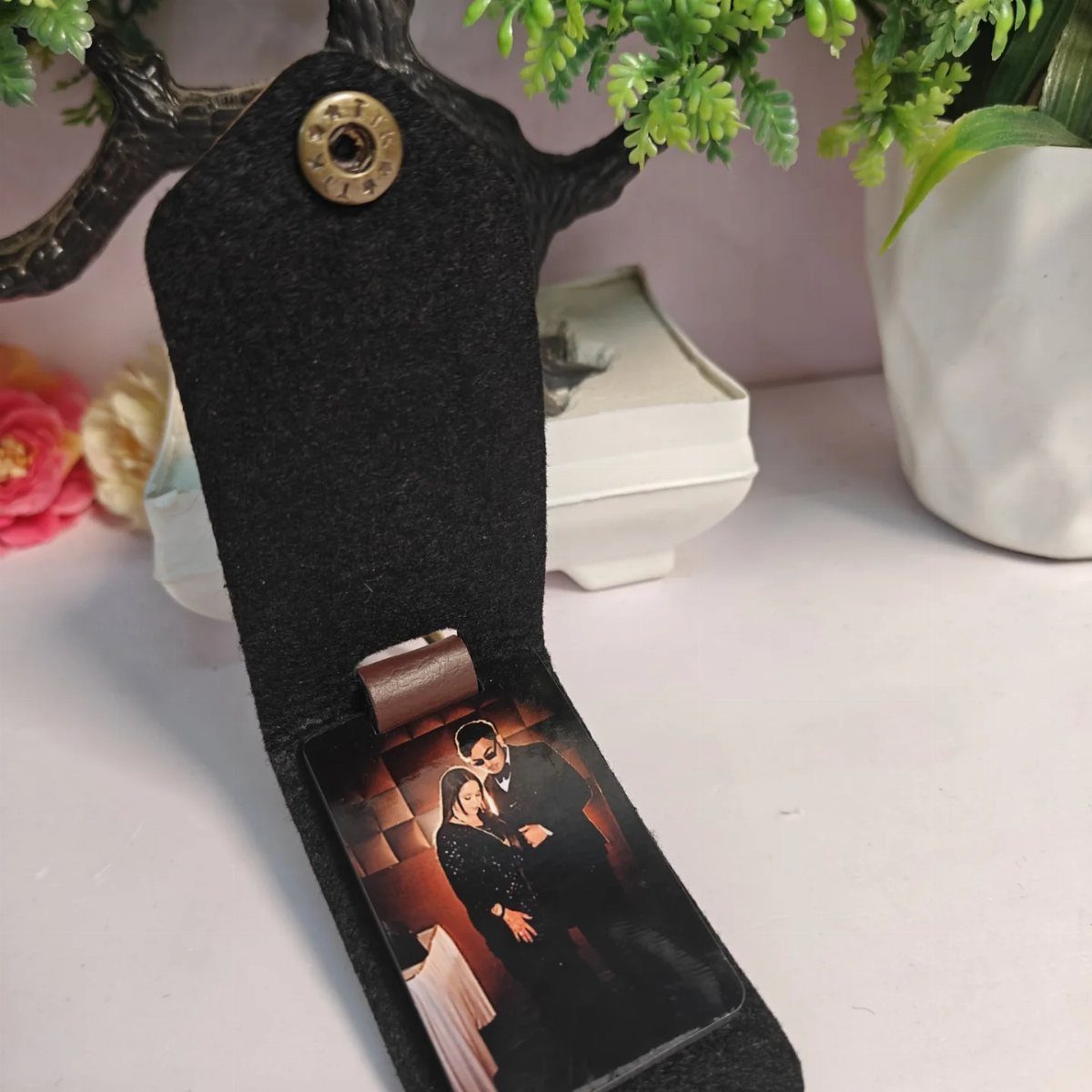 Black felt handmade photo holder displaying a picture of a couple