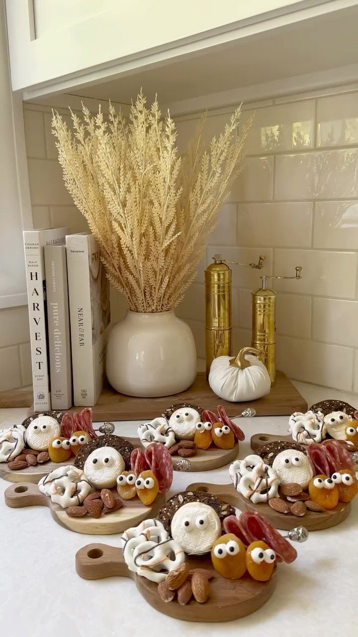 Mini wooden cheese boards with food arranged to look like cute faces.