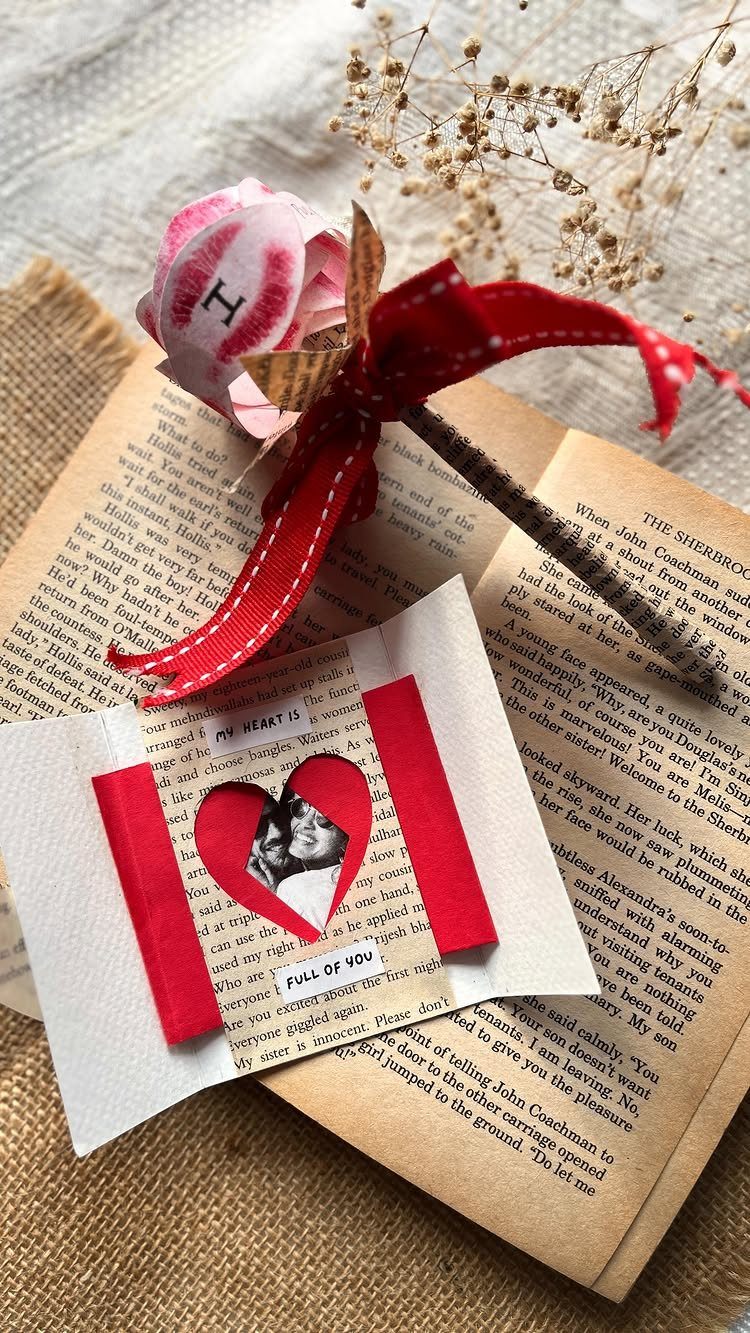 Handmade Valentine's card with a photo heart resting on an open vintage book.