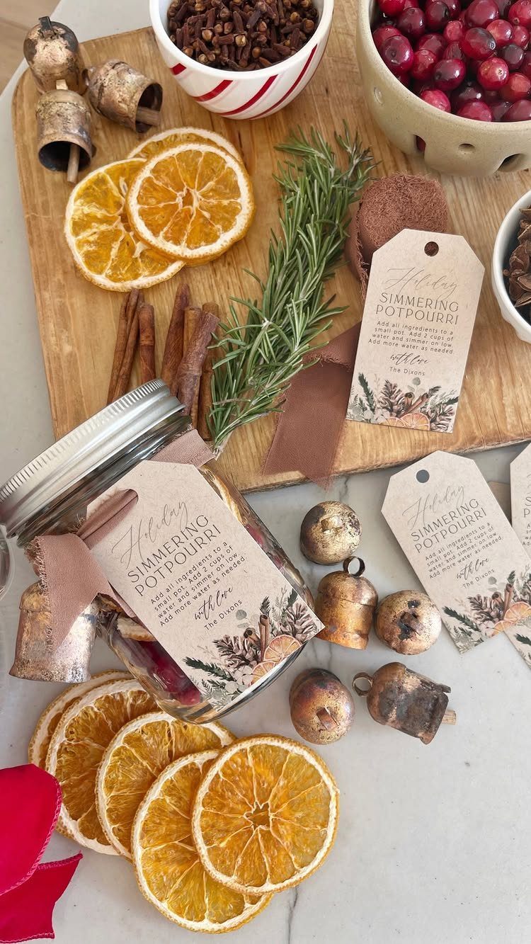 Mason jar of simmering potpourri with dried oranges, cinnamon, and rosemary on wood.