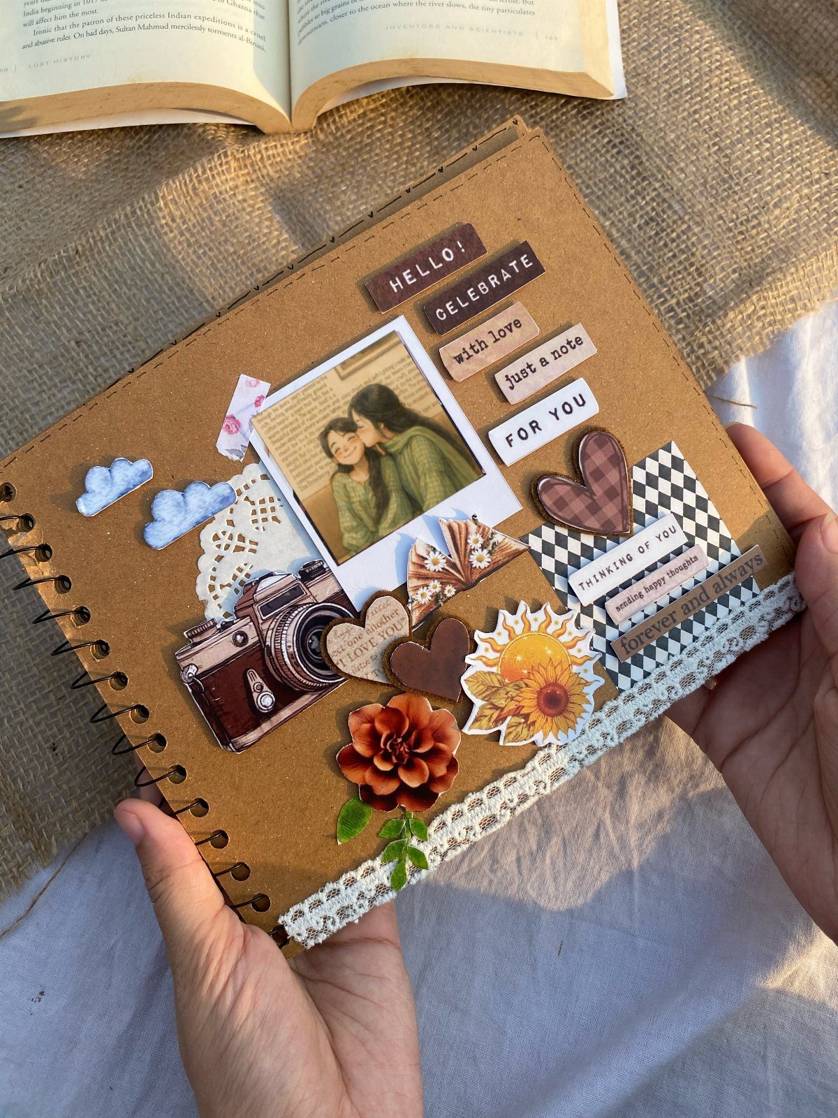 Handmade photo scrapbook with a couple's picture, vintage camera, and floral decorations.
