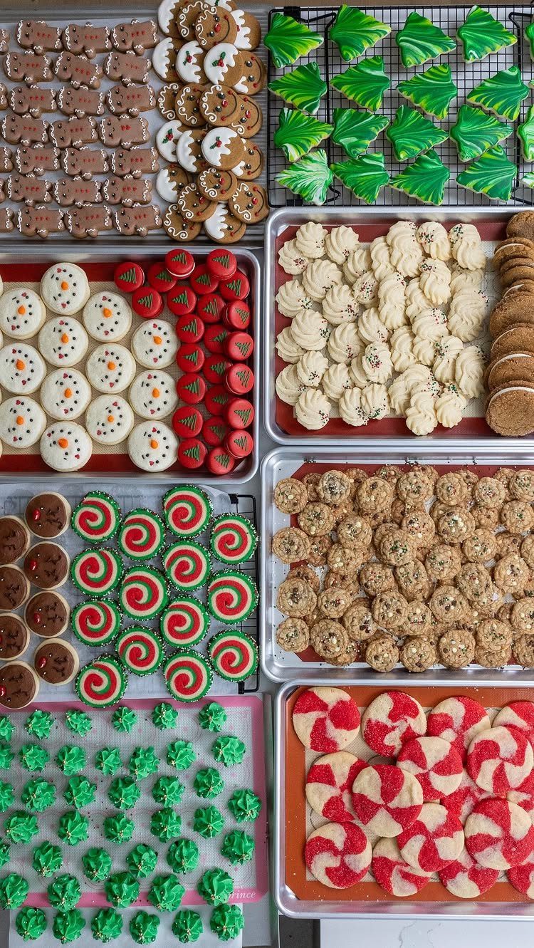 Assorted Christmas cookies in various shapes and colors arranged on baking trays.
