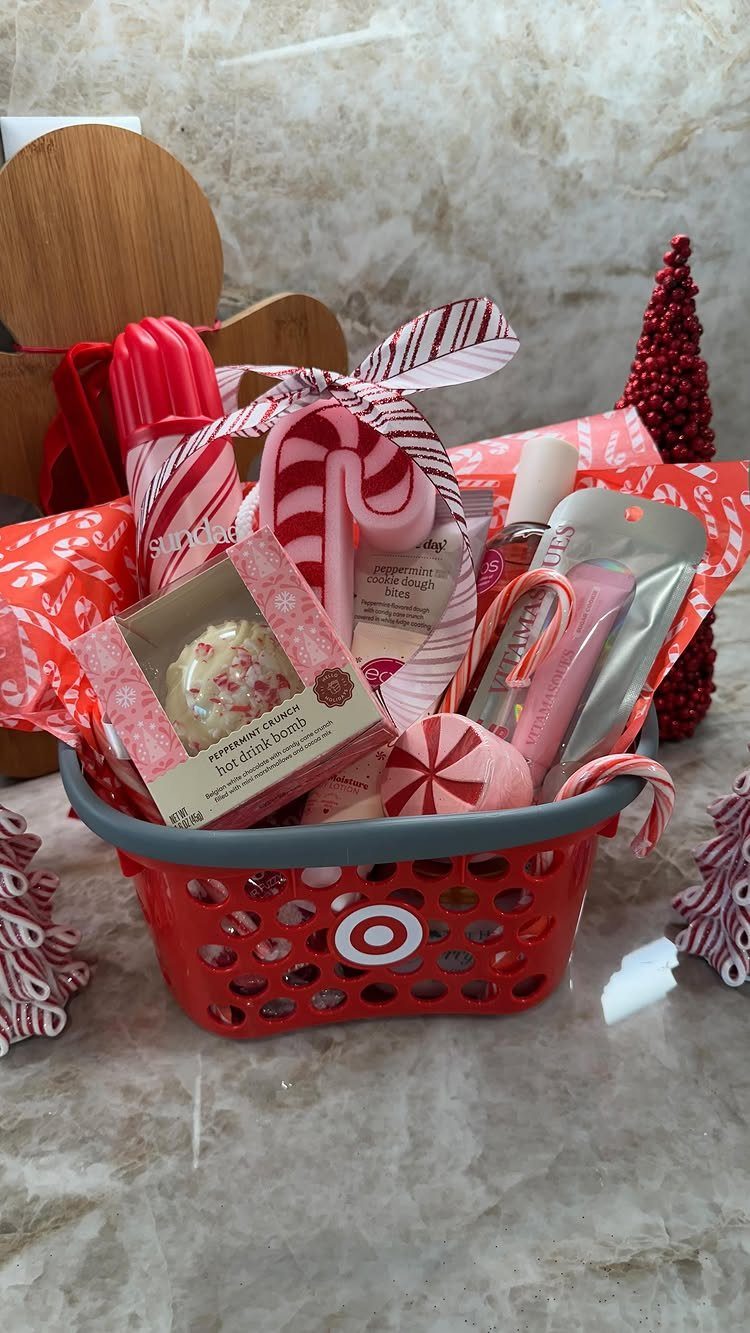 Red gift basket filled with candy canes, beauty products, and holiday treats.