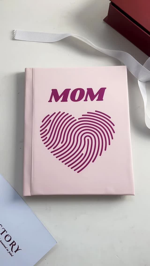 Pink hardcover book for Mom with a purple fingerprint heart on the cover.