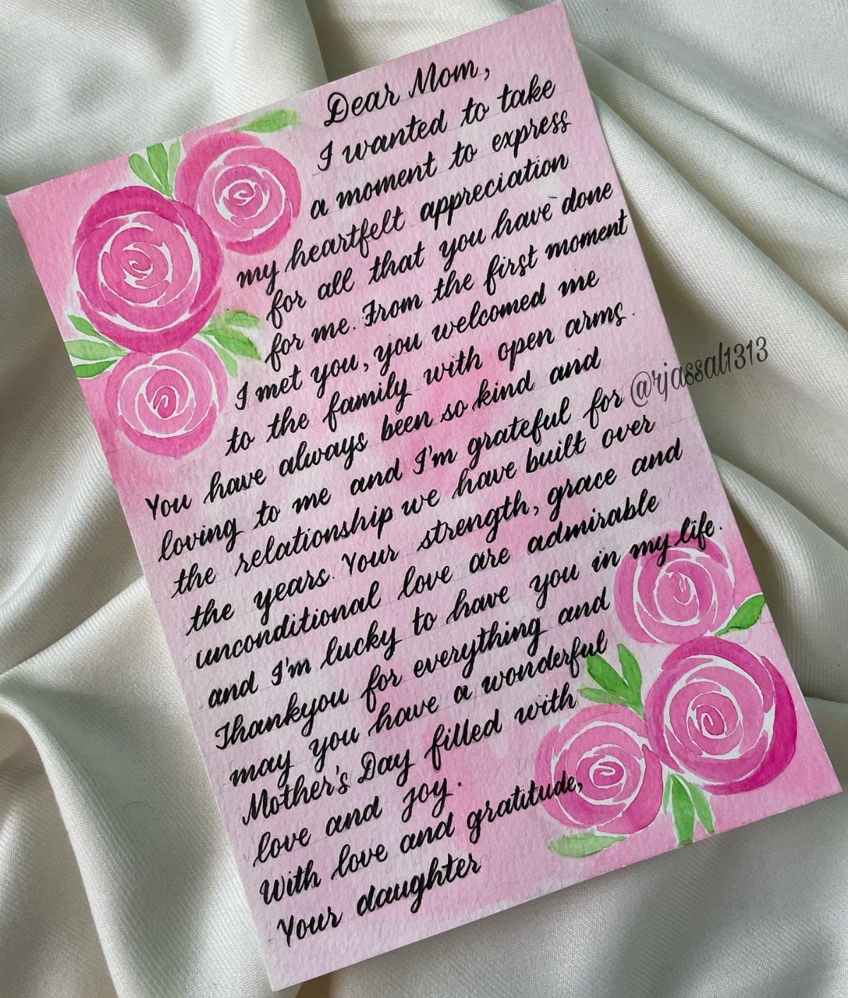 Handwritten Mother's Day letter with pink rose illustrations on a white fabric background.