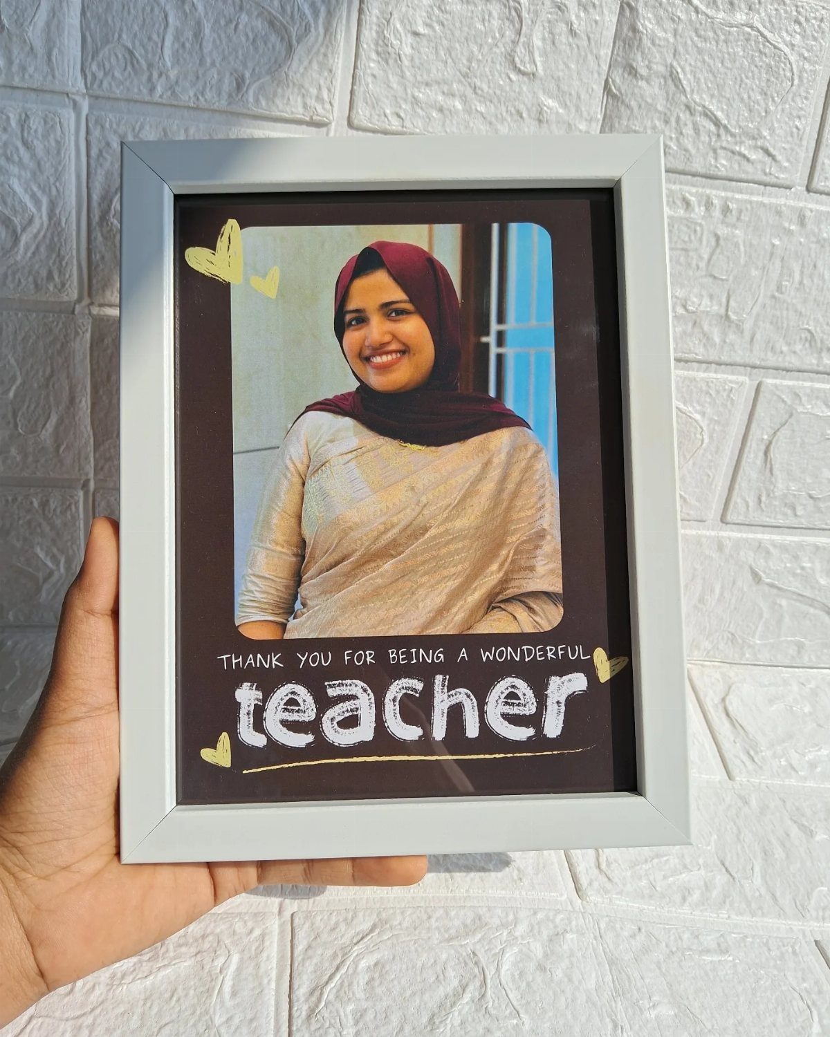 White picture frame with a photo of a teacher and thank you text.