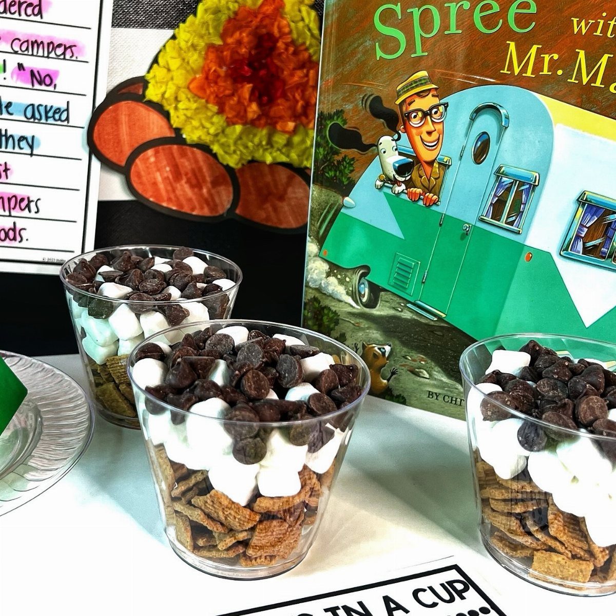 S'mores kits in clear plastic cups with graham crackers, marshmallows, and chocolate chips.