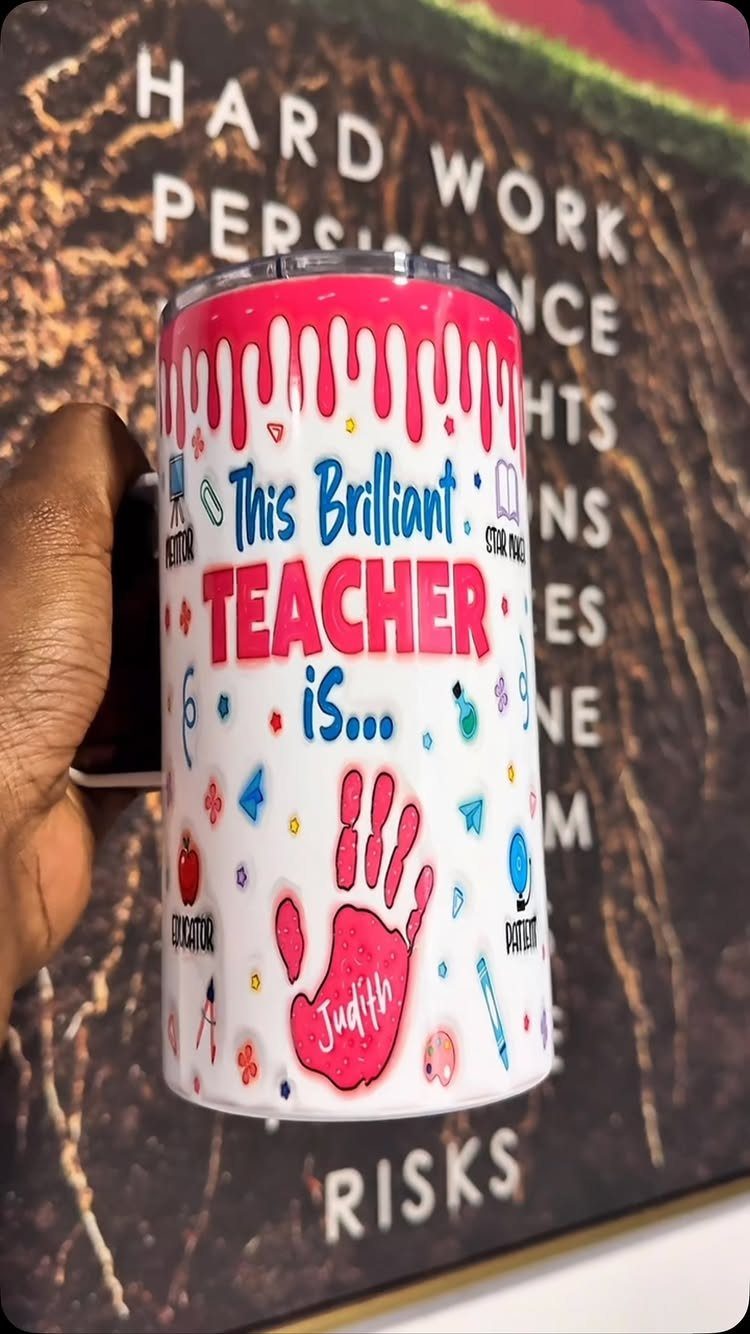Personalized white travel mug for a teacher with a pink handprint and text.