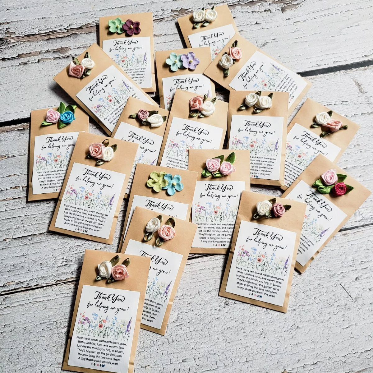 Small brown seed packets with thank you notes and colorful clay flower decorations.