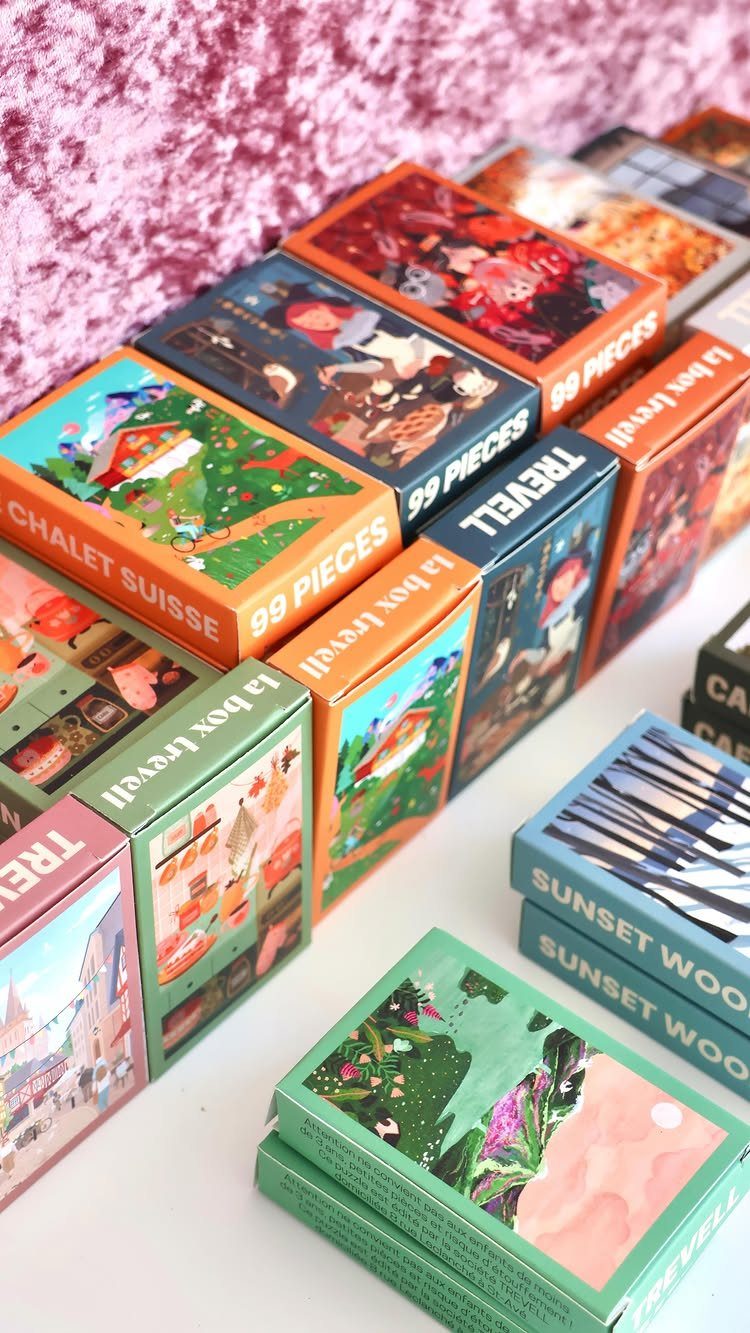 Colorful illustrated playing card decks arranged in rows on a white surface.