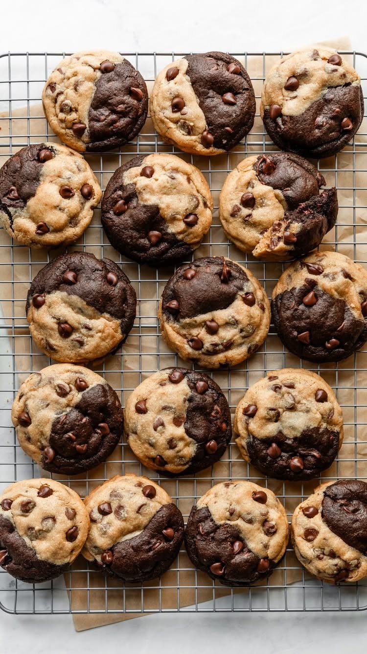 Marbled chocolate chip cookies cooling on a metal wire rack over parchment paper.