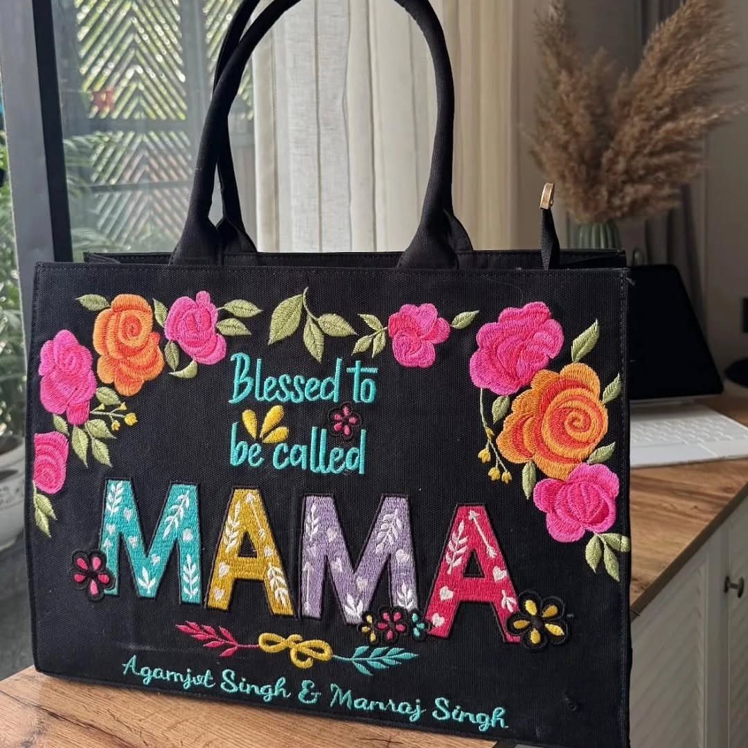 Black tote bag with colorful embroidered roses and the word MAMA on it.