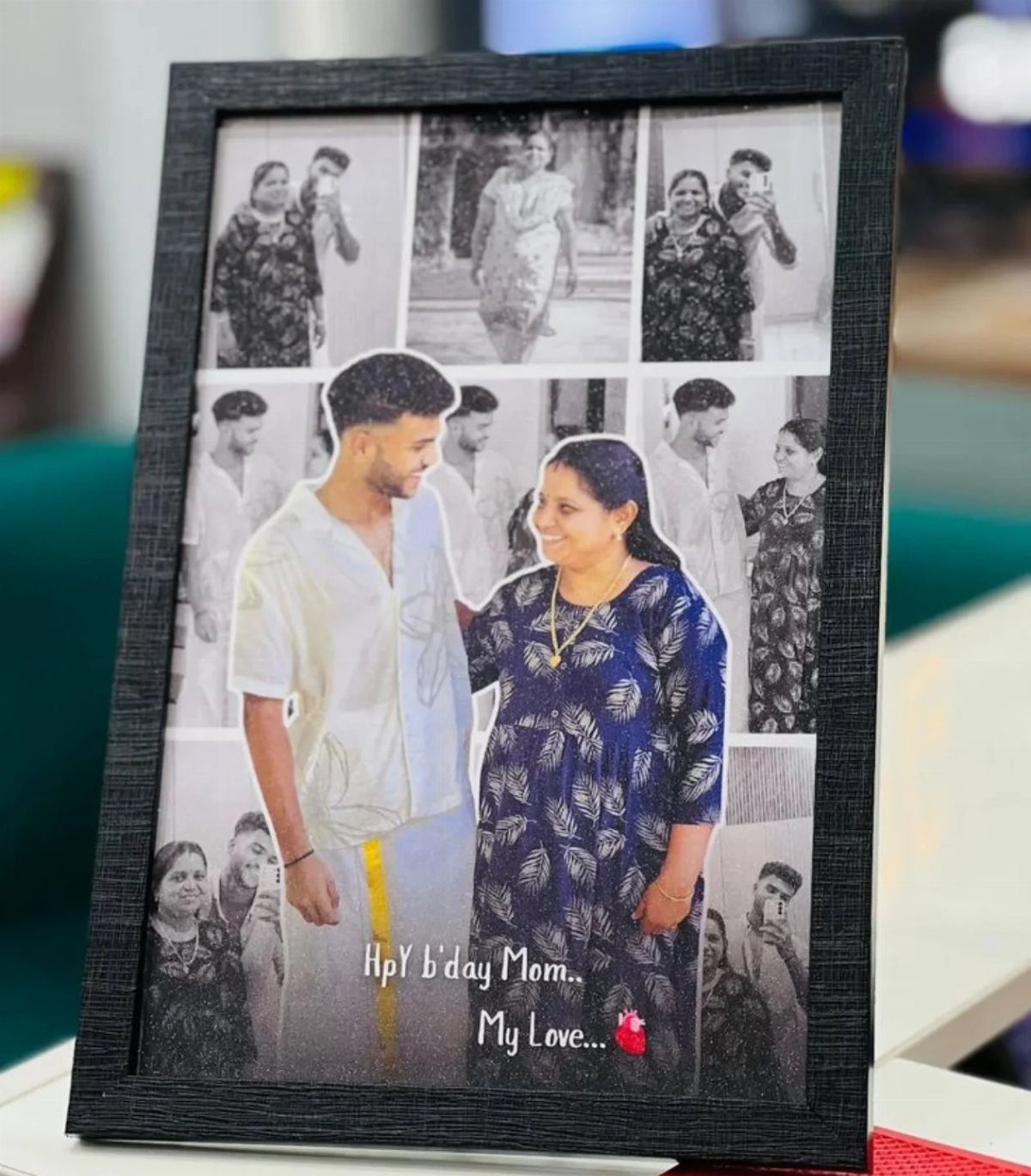 Black picture frame containing a photo collage of a son and mother.