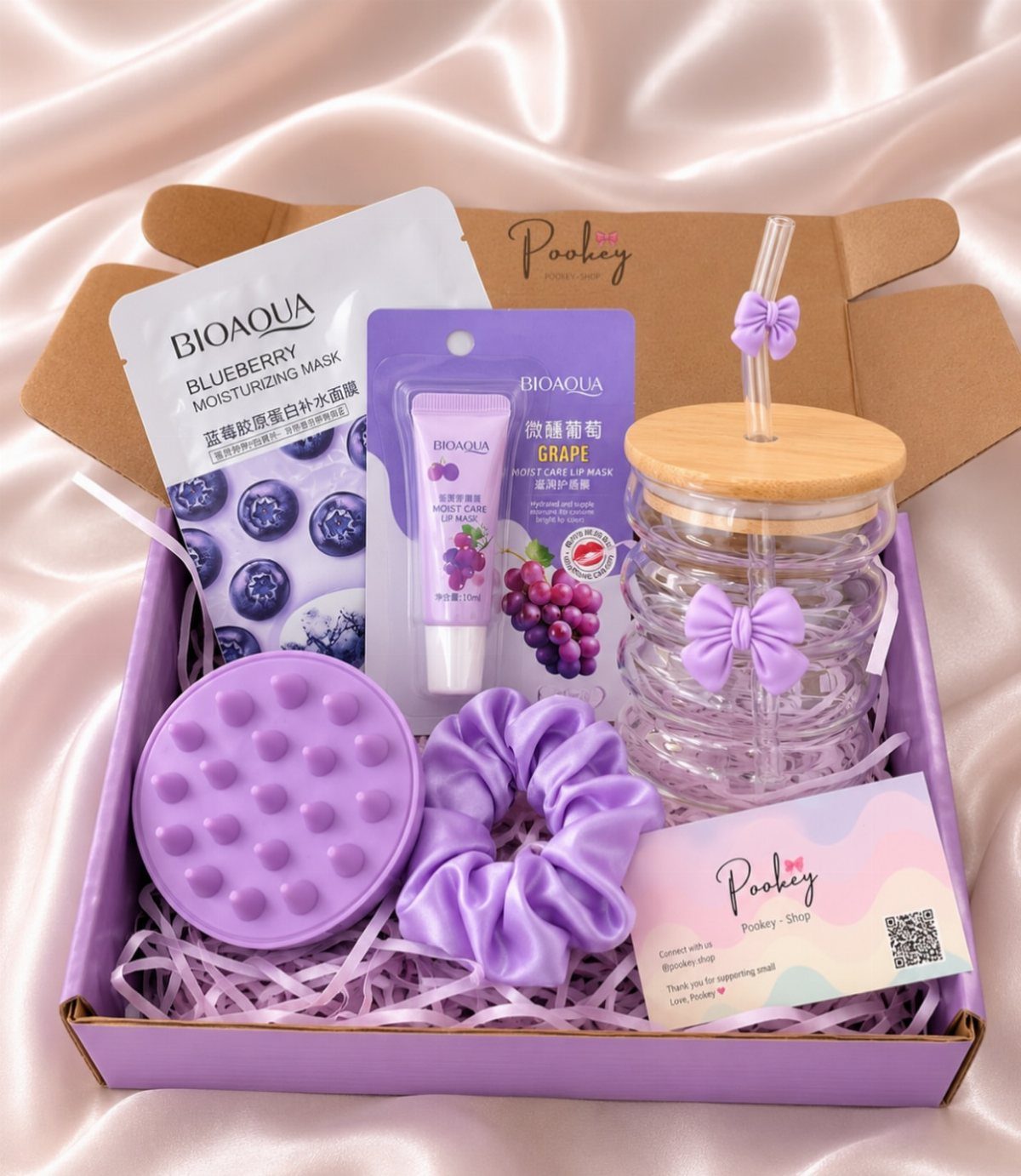 Purple beauty gift box with lip mask, face mask, scrunchie, and glass tumbler.