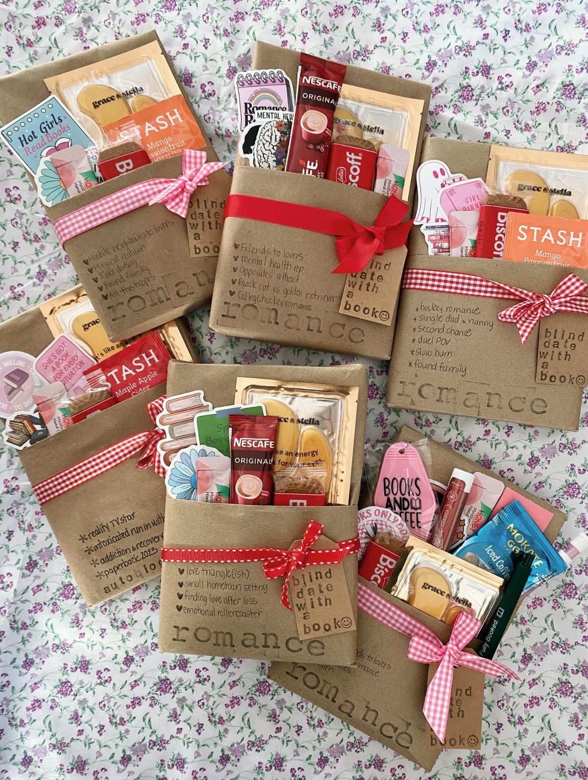 Brown paper gift bags filled with treats and books on floral fabric.