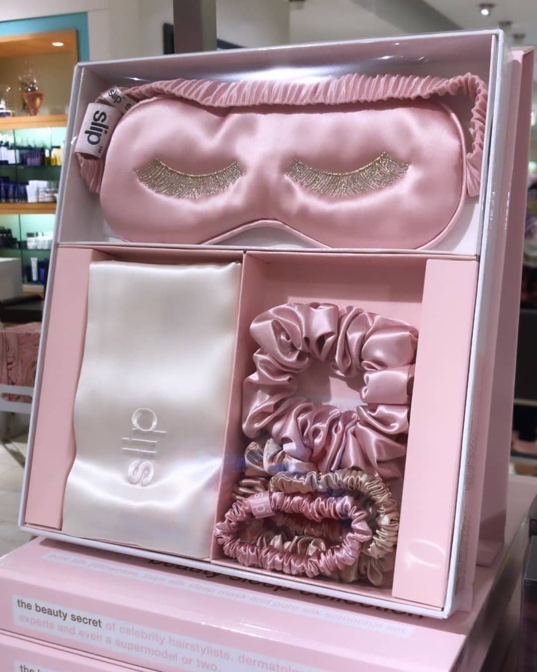 Pink silk sleep mask and scrunchies set in a white gift box.