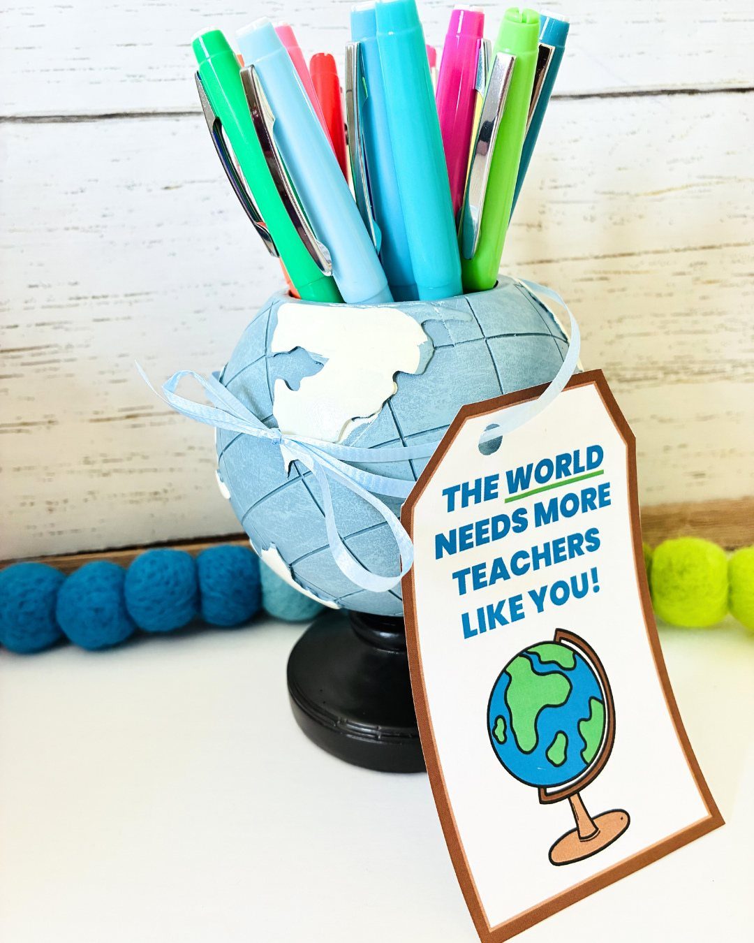 Globe pen holder with colorful pens and a teacher appreciation gift tag.