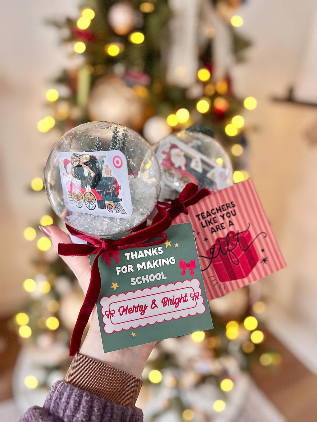 Snow globe gifts with festive teacher gift tags and red velvet ribbons.